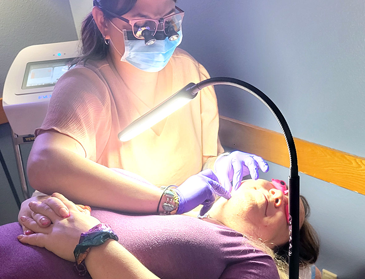 For transgender women with gender dysphoria due to facial hair, electrolysis can offer a permanent hair removal solution. | Electrologist with client shown.